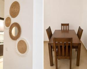 a dining room table with two chairs and a mirror at cosy and comfortable stay in Oued Laou