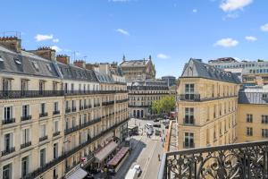 a view of a city street with buildings at Excelsior Opera in Paris