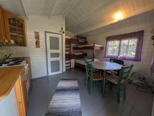 a kitchen with a table and chairs in a room at Bondegårdsparken Farm Holiday in Kristiansand