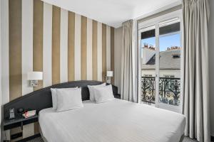 a bedroom with a large bed and a window at Excelsior Opera in Paris +80 photos