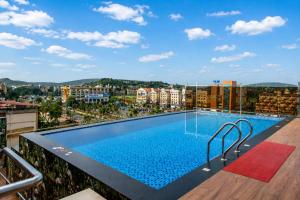 a swimming pool on the roof of a building at Hotel Eagle Empire in Madgaon