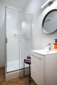 a bathroom with a shower and a sink and a mirror at Bohem Prague Hotel in Prague