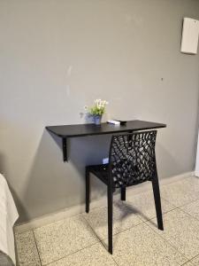 a black table with a plant on top of it at CaisSuites in Cabo Frio +48 photos