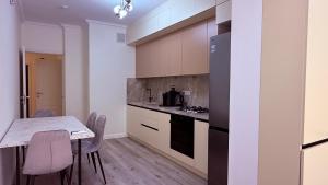 a kitchen with a table and chairs and a counter top at Apartment OneClickRent 16 in Chişinău