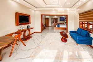 a living room with a blue couch and a bed at Mozza Beach Resort in York