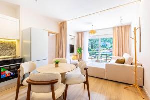 a living room with a table and a couch at Dhermi's Icon Big 1BR Apt 10 in Dhërmi +6 photos
