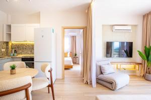 a kitchen and living room with a white refrigerator at Dhermi's Icon Big 1BR Apt 10 in Dhërmi