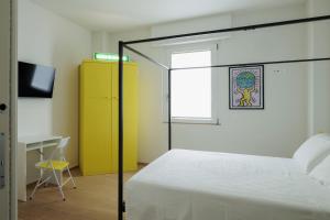 a bedroom with a bed and a yellow cabinet at VItruVIo POP in Fano