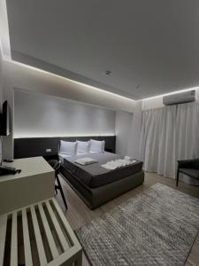 a bedroom with a bed and a desk and a couch at Grand Museum Pyramids in Cairo +91 photos
