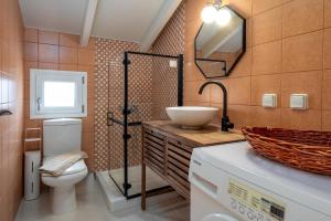a bathroom with a sink and a toilet and a mirror at Trithea Seaview Villa with Pool Quiet and Relaxing in Vlachata +30 photos