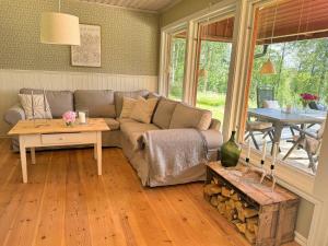 a living room with a couch and a table at Hus Bjöksjöblick in Hällefors