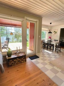 a living room with a fireplace and a table at Hus Bjöksjöblick in Hällefors +27 photos