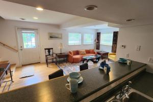 a living room with a kitchen and a living room with a couch at Shelburne Falls on Main in Shelburne