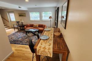 a living room with a table and a couch at Shelburne Falls on Main in Shelburne