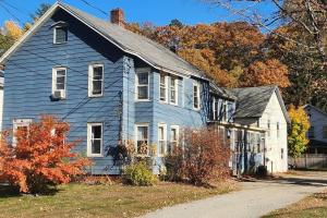 an old blue house in the middle of a street at Shelburne Falls on Main in Shelburne
