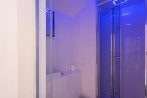 a bathroom with a shower with a toilet and a sink at Spacious 3BR Family Home with Big Garden in Manchester