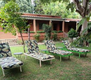 a group of chairs sitting in the grass at Hôtel Mahavelo 2 étoiles in Antananarivo