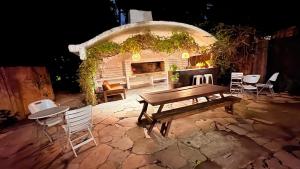 a patio with a table and chairs and a fireplace at Posada CASA in Punta del Este