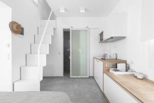 a bathroom with white walls and a sink and a staircase at Twiins Studios by halu! - Next to Kallithea Beach in Kallithea Halkidikis +5 photos
