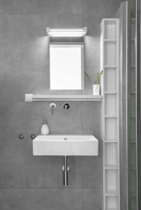 a bathroom with a white sink and a mirror at Twiins Studios by halu! - Next to Kallithea Beach in Kallithea Halkidikis