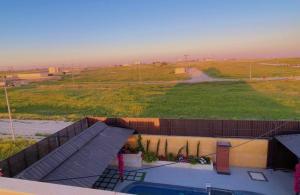 a building with a view of a field and a road at Villa Al Wesam in Amman +3 photos