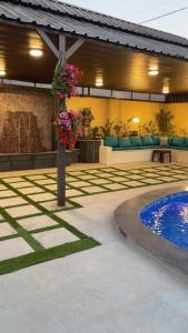 a patio with a swimming pool and a building at Villa Al Wesam in Amman