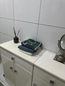 a bathroom counter with a towel and a mirror at Park Poleski - Sosnowe Zacisze in Grabniak +27 photos