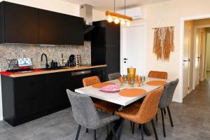 a kitchen and dining room with a table and chairs at BEACH house in Westende-Bad