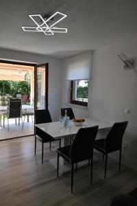 a dining room with a table and chairs at Apartma Mija - XL in Kornić