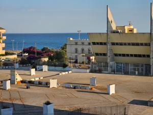 a large building with the ocean in the background at Holidaysshogun 2 in Lido di Ostia