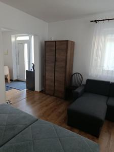 a living room with a couch and a cabinet at Chalúpka Liptov in Lúčky