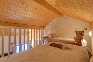 a room with a bed with a laptop on it at Mountain Lodge in Alps-chez Philippe, Panoramic-Village, Renting, view over Glaciers in La Grave
