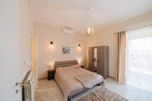 a bedroom with a bed and a large window at Guest House Michele in Orvieto Scalo