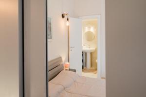 a bathroom with a bed and a sink and a mirror at Guest House Michele in Orvieto Scalo +21 photos