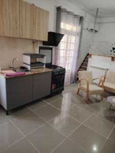 a kitchen with a sink and a stove in a room at Dany house in Aïn El Turk +3 photos