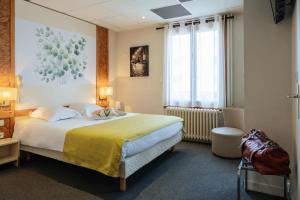 a hotel room with a large bed and a window at Logis Hôtel Restaurant Bellevue Annecy in Annecy