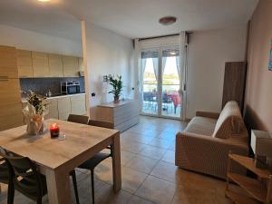 a kitchen and living room with a table and chairs at Holidaysshogun 2 in Lido di Ostia