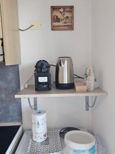 a kitchen shelf with a toaster and other items on it at Holidaysshogun 2 in Lido di Ostia