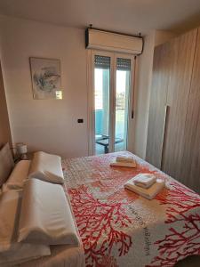 a bedroom with a bed with two towels on it at Holidaysshogun 2 in Lido di Ostia