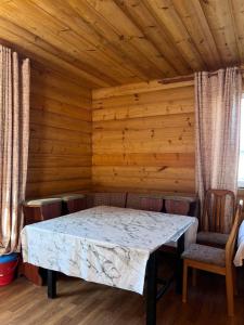 a dining room with a table and chairs at Деревянный домик in Dolinka