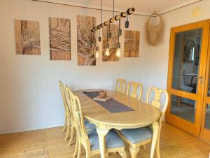 a dining room with a wooden table and chairs at Hus Gillberga in Varmlands Nysater