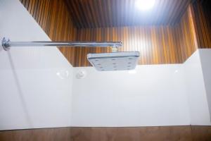 a bathroom with a white toilet in a room at Hotel Orbit in Parbhani