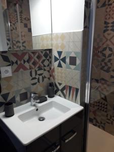 a bathroom with a white sink and a shower at cosy à Blois in Blois