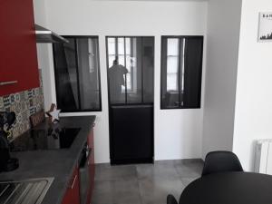a man standing in the doorway of a kitchen at cosy à Blois in Blois
