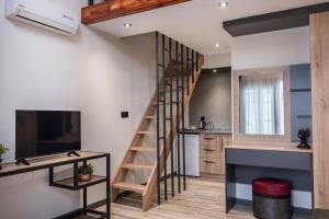 a spiral staircase in a kitchen with a living room at Ladik Hotel in Karahayit