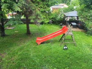 a red slide in a yard with a gazebo at Purje in Pärnu
