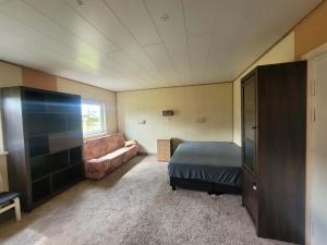 a bedroom with a bed and a couch at Purje in Pärnu