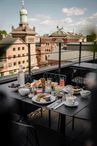 a table with food and drinks on a balcony at Boutique Hotel Ottilia in Copenhagen