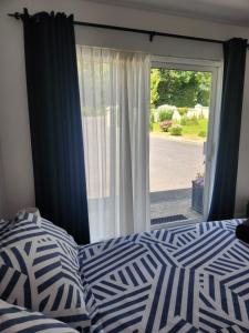 a bedroom with a bed and a large window at The Lodge in Killarney