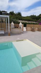 a swimming pool in a yard next to a patio at Ripamè B&B in Ripa Teatina
